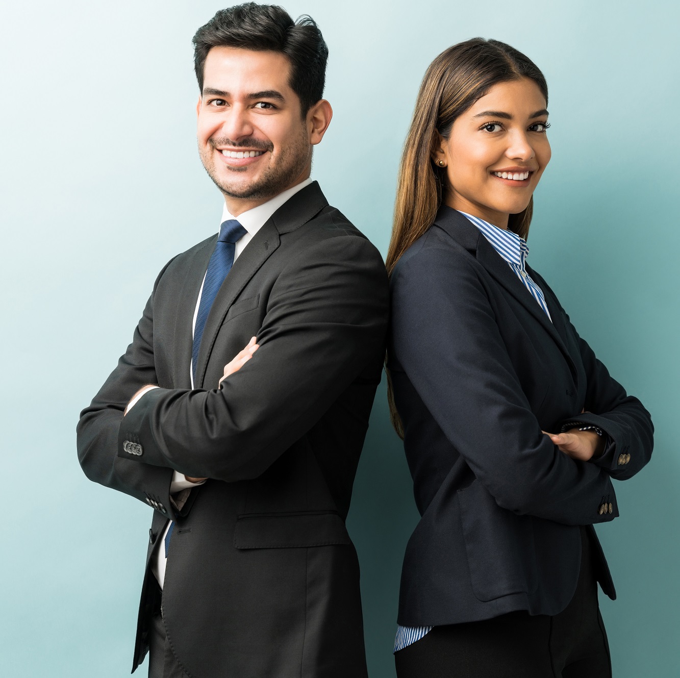 Business Colleagues Standing With Arms Crossed In Studio